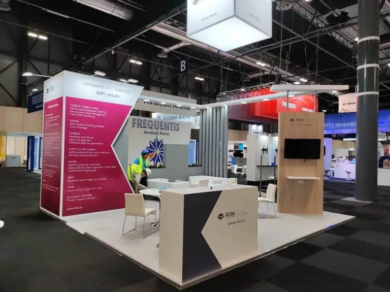 RISK Company aviation information management exhibition booth with magenta graphics at European airspace industry event