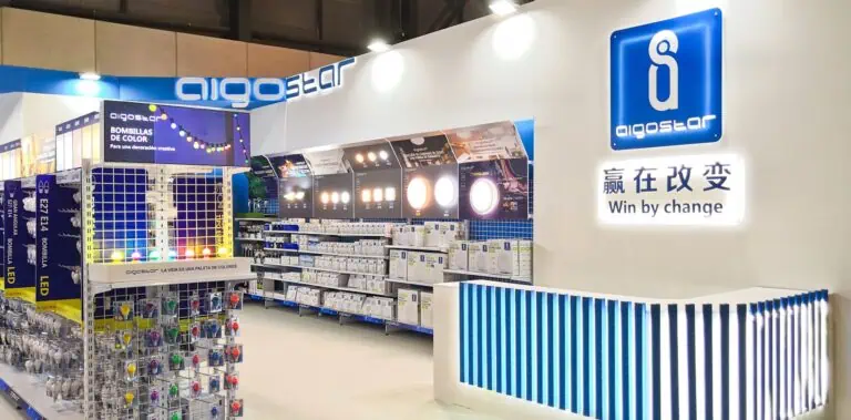 Aigostar LED lighting exhibition stand with illuminated logo wall and product shelving at Intergift IFEMA Madrid