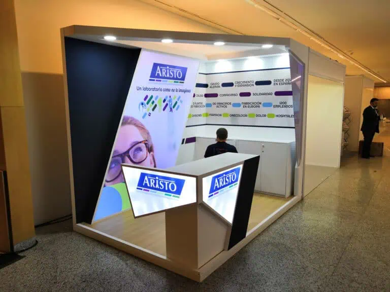 ARISTO Pharma compact congress booth with angled backlit graphics and branded counter at pharmaceutical event in Spain