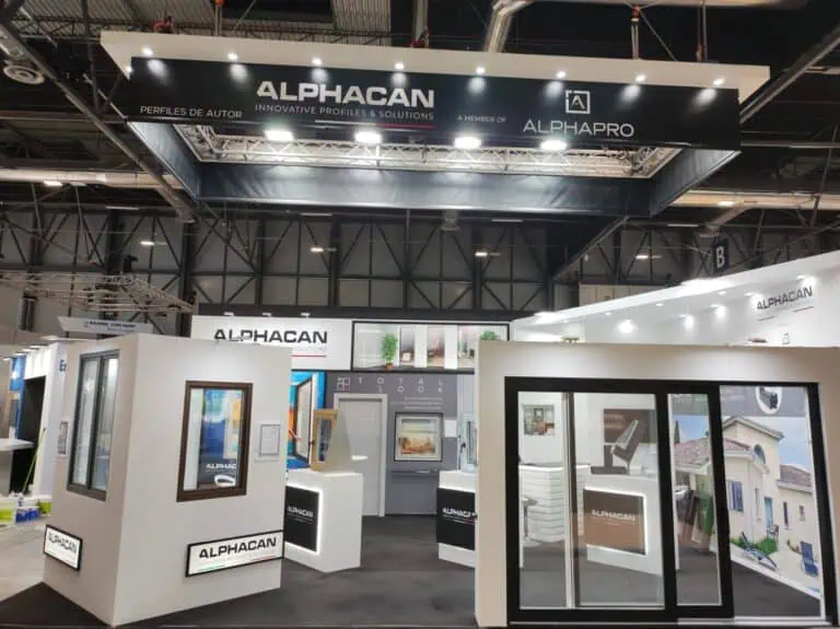 ALPHACAN window profile exhibition stand with truss-hung banner and product display towers at Veteco IFEMA Madrid