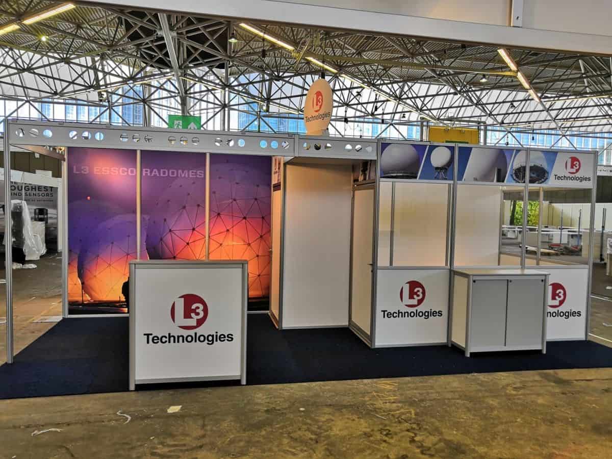 L3 Technologies modular exhibition booths with space themed graphics during trade fair build-up in Europe