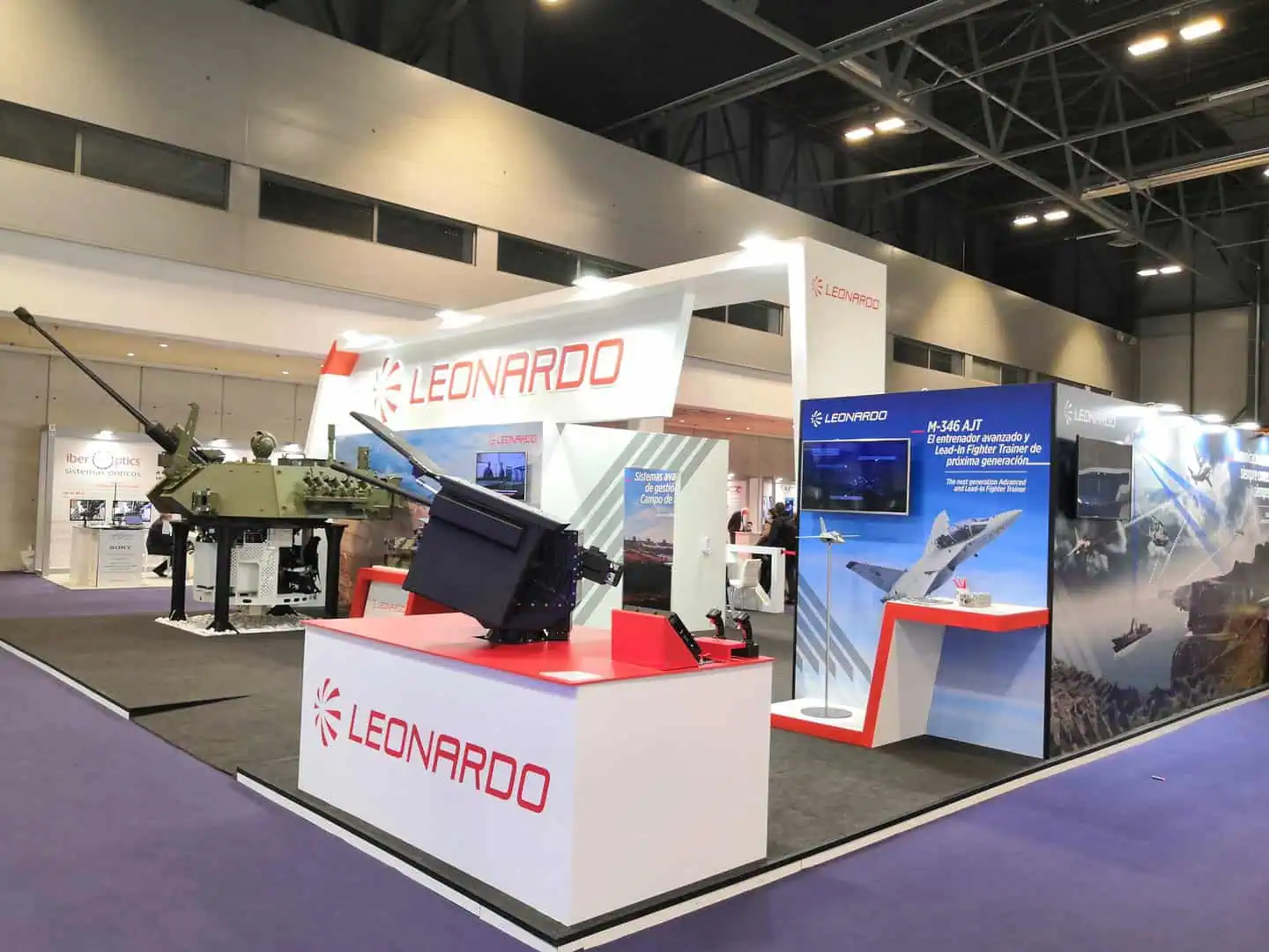 Leonardo defence exhibition stand with turret and trainer aircraft displays at FEINDEF IFEMA Madrid