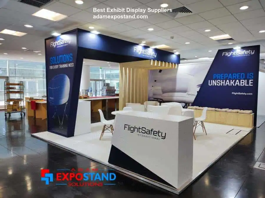 Custom exhibition stand built by Adam Expo Stand for FlightSafety International with illuminated reception counter and branded graphics